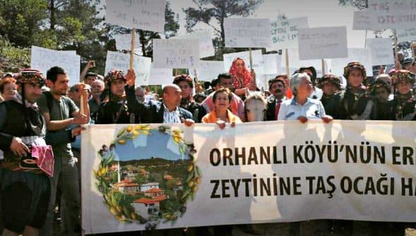 Group of protesters holding banners and signs during a demonstration in Orhanlı Village against a quarry operation. - Olive Oil Times