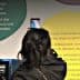 Two women viewing informational displays about health benefits of olive oil at an exhibit. - Olive Oil Times