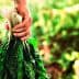 Individual holding a bunch of fresh leafy greens in their hand. - Olive Oil Times