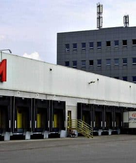 Exterior view of the Konzum distribution center with loading docks and delivery trucks. - Olive Oil Times