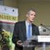 Francesco Visioli speaking at the International Conference on Food Values with a presentation backdrop. - Olive Oil Times