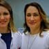Two women smiling in a laboratory environment, one wearing a lab coat and the other in a white sweater. - Olive Oil Times