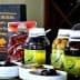 Bottles of olive oil, olives, and other products from Olivicola Simone displayed on a table. - Olive Oil Times