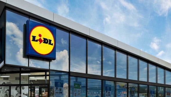 Exterior view of a Lidl supermarket building with large glass windows and a prominent logo. - Olive Oil Times
