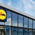 Exterior view of a Lidl supermarket building with large glass windows and a prominent logo. - Olive Oil Times