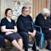 Six elderly women dressed in black and gray sitting on a bench in a casual setting. - Olive Oil Times