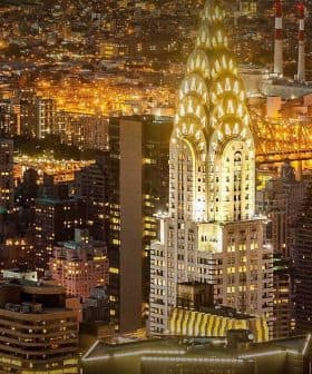Chrysler Building illuminated at night among other skyscrapers in New York City. - Olive Oil Times