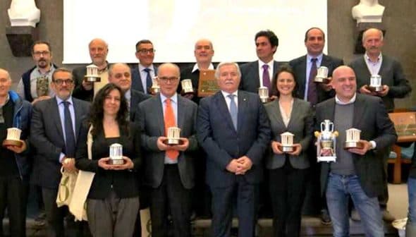 Group photo of winners holding awards at the 26th Ercole Olivario event. - Olive Oil Times