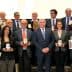Group photo of winners holding awards at the 26th Ercole Olivario event. - Olive Oil Times