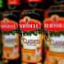 Bottles of Bertolli Classico and Extra Light olive oil lined up on a shelf. - Olive Oil Times