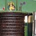 Olive oil pressing machine with a religious icon and flowers on top of it. - Olive Oil Times
