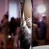 Statue of Liberty model displayed prominently at an indoor event with blurred background attendees. - Olive Oil Times