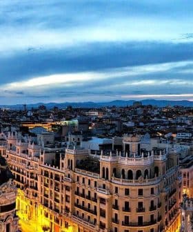 Panoramic view of Madrid's skyline featuring buildings and a twilight sky. - Olive Oil Times