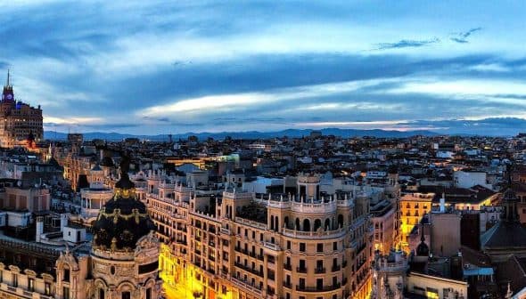 Panoramic view of Madrid's skyline featuring buildings and a twilight sky. - Olive Oil Times