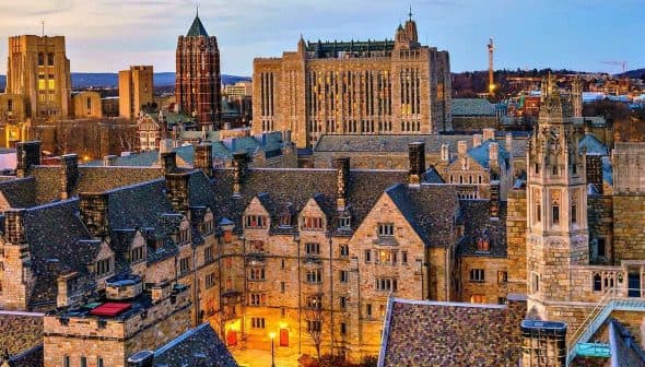 Aerial view of Yale University campus showcasing historic buildings and architecture at dusk. - Olive Oil Times