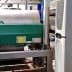 Industrial machinery used for olive oil processing, featuring a green motor and stainless steel tanks. - Olive Oil Times