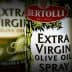 Three bottles of Bertolli extra virgin olive oil, including a spray option and fruity taste variant. - Olive Oil Times