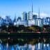 Cityscape of Sao Paulo featuring skyscrapers and reflections in water during dusk. - Olive Oil Times