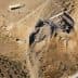 Aerial view of an archaeological site with excavation areas and surrounding terrain. - Olive Oil Times