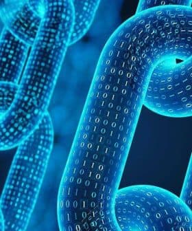 3D illustration of interconnected chains with binary code representing blockchain technology. - Olive Oil Times