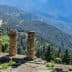 Stone columns of the ancient ruins at Delphi overlooking a mountainous landscape. - Olive Oil Times