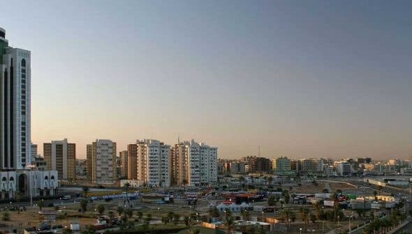Panoramic view of Tripoli skyline featuring modern buildings and a clear sky. - Olive Oil Times