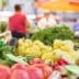 Assorted fresh vegetables including tomatoes, peppers, and cucumbers displayed at a market stall. - Olive Oil Times