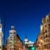 Night view of a cityscape in Madrid featuring illuminated buildings and streetlights. - Olive Oil Times