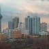 Cityscape of Tehran featuring the Milad Tower and various buildings under a cloudy sky. - Olive Oil Times