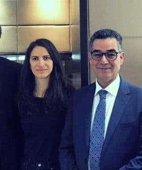 Four individuals in formal attire standing together in an indoor setting. - Olive Oil Times