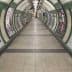 Interior view of a London Underground tunnel featuring artwork on the walls and signage for the Bakerloo Line. - Olive Oil Times