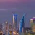 Skyline of Riyadh featuring modern skyscrapers illuminated at dusk with a purple sky. - Olive Oil Times