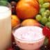 A glass of milk and a bowl of yogurt surrounded by various fruits and vegetables. - Olive Oil Times