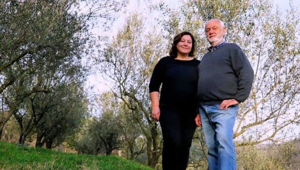 Orjana Hrvatin and Timotej Zupan standing together in an olive grove. - Olive Oil Times