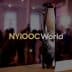 A crystal trophy with the inscription 'NYIOOC World' prominently displayed in a blurred background. - Olive Oil Times