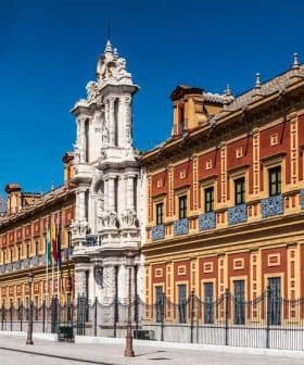 Historical building in Seville featuring an ornate facade and decorative elements. - Olive Oil Times