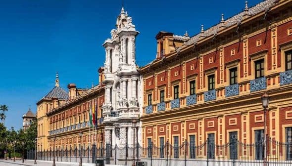 Historical building in Seville featuring an ornate facade and decorative elements. - Olive Oil Times