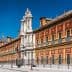 Historical building in Seville featuring an ornate facade and decorative elements. - Olive Oil Times