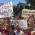 Crowd of people holding signs during a protest in Jaén, Spain, advocating for agricultural issues. - Olive Oil Times
