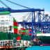 Two large container ships docked at a port with colorful shipping containers stacked on them. - Olive Oil Times