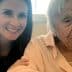 A woman with long dark hair smiling next to an elderly lady with gray hair wearing a light pink blouse. - Olive Oil Times
