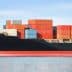 Large container ship with stacked colorful cargo containers on the deck in calm waters. - Olive Oil Times