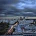 A panoramic view of Madrid's skyline during dusk with cloudy skies and city lights. - Olive Oil Times