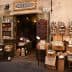 Entrance of a traditional Italian grocery store with various products displayed outside. - Olive Oil Times
