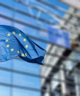 European Union flag with twelve stars on a blue background, waving in the wind. - Olive Oil Times