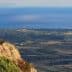 Panoramic view of the coastline and distant island from a rocky outcrop. - Olive Oil Times