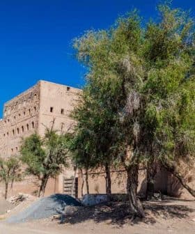 A historic fortification structure with trees in the foreground against a clear blue sky. - Olive Oil Times