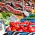 Colorful assortment of fresh vegetables and fruits arranged in crates at a market. - Olive Oil Times