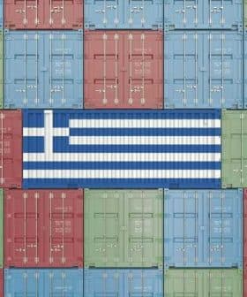 Shipping containers arranged in a pattern with the Greek flag in the center. - Olive Oil Times