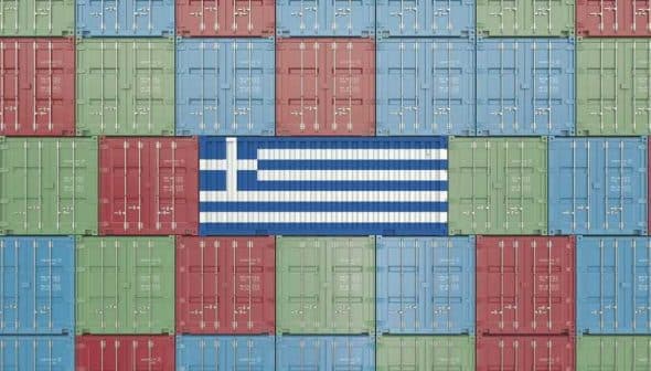 Shipping containers arranged in a pattern with the Greek flag in the center. - Olive Oil Times